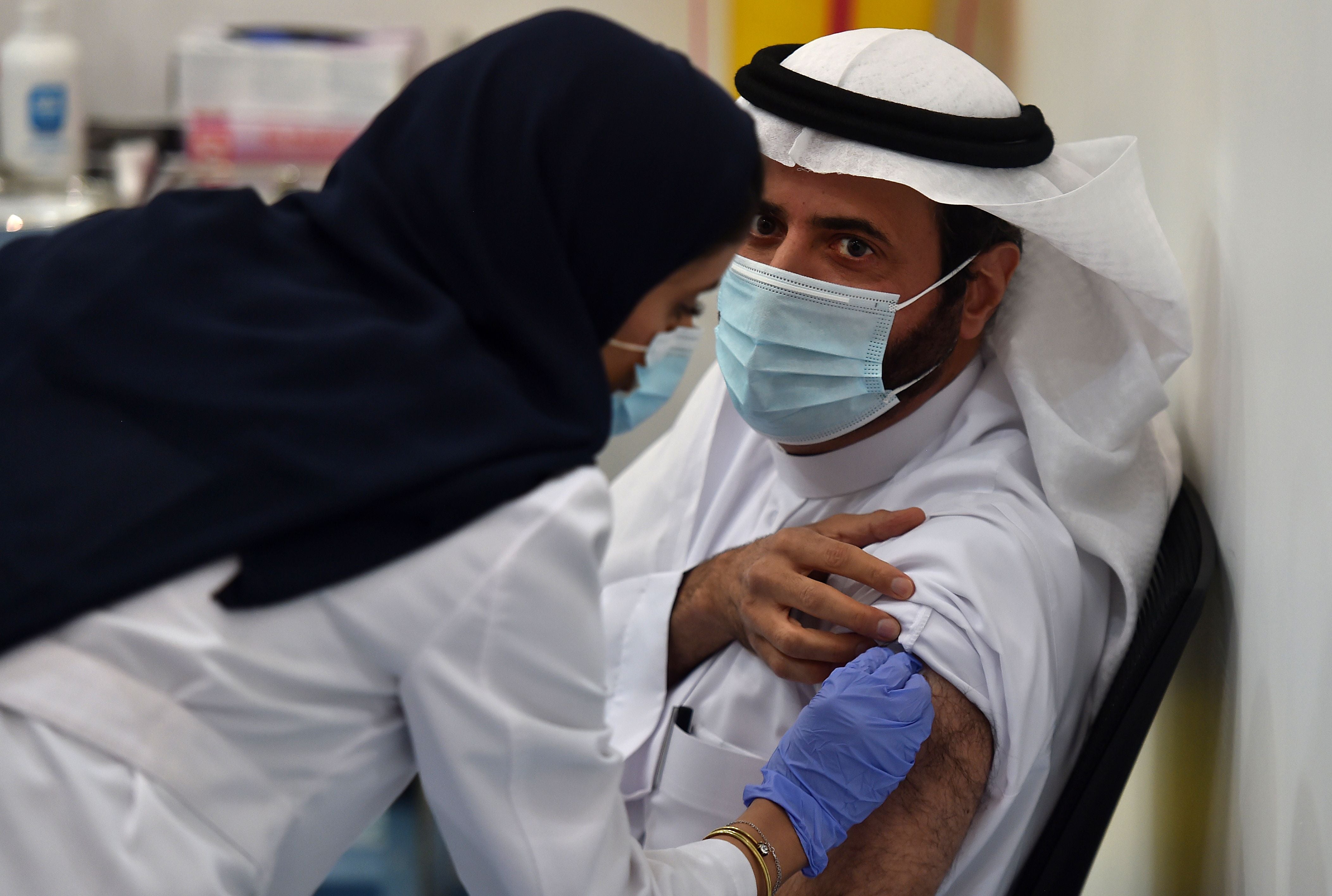 Saudi Arabia’s Health Minister Tawfiq al-Rabiah receiving the Pfizer-BioNTech COVID-19 coronavirus vaccine (Photo by FAYEZ NURELDINE/AFP via Getty Images)