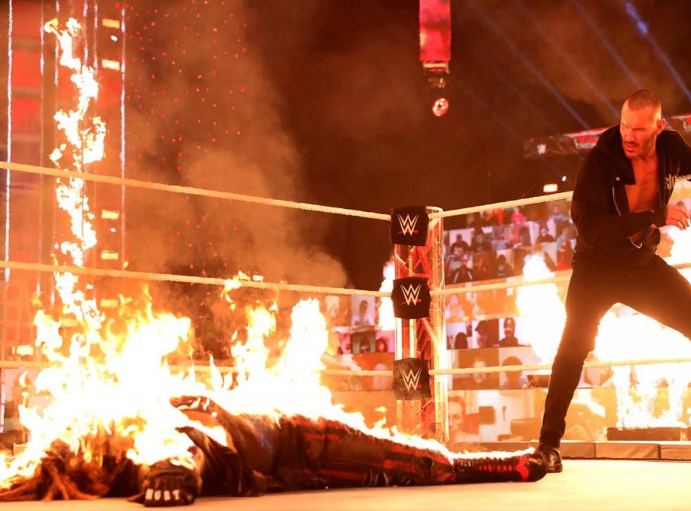 Randy Orton watches on after setting Bray Wyatt on fire at WWE TLC