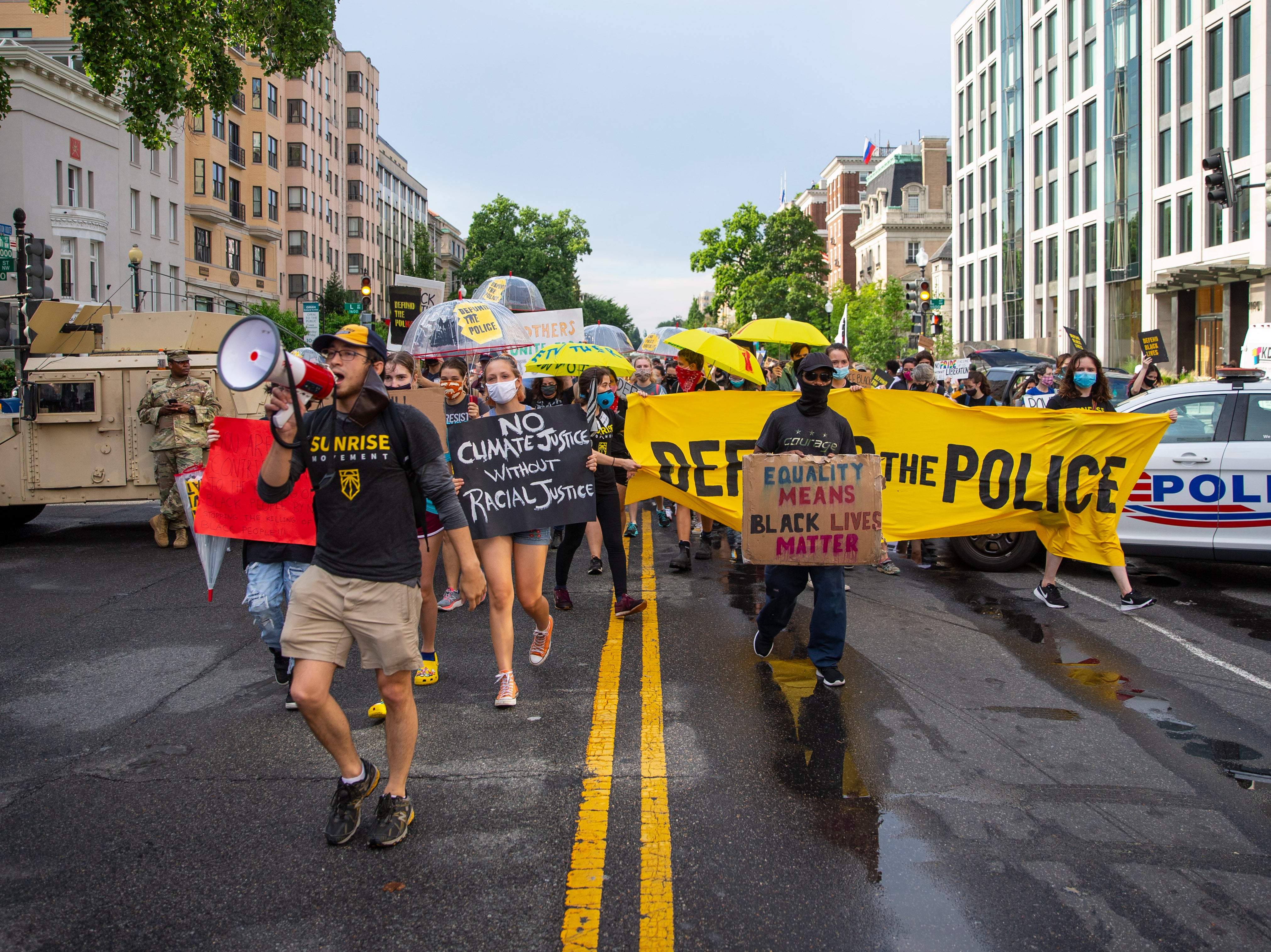 A group of Sunrise activists walk towards Black Lives Matter Plaza as people gather to celebrate Juneteenth in Washington DC