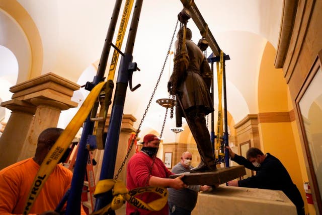 This Monday, 21 December 2020 photo provided by the Office of the Governor of Virginia shows workers removing a statue of Confederate Gen. Robert E Lee from the National Statuary Hall Collection in Washington