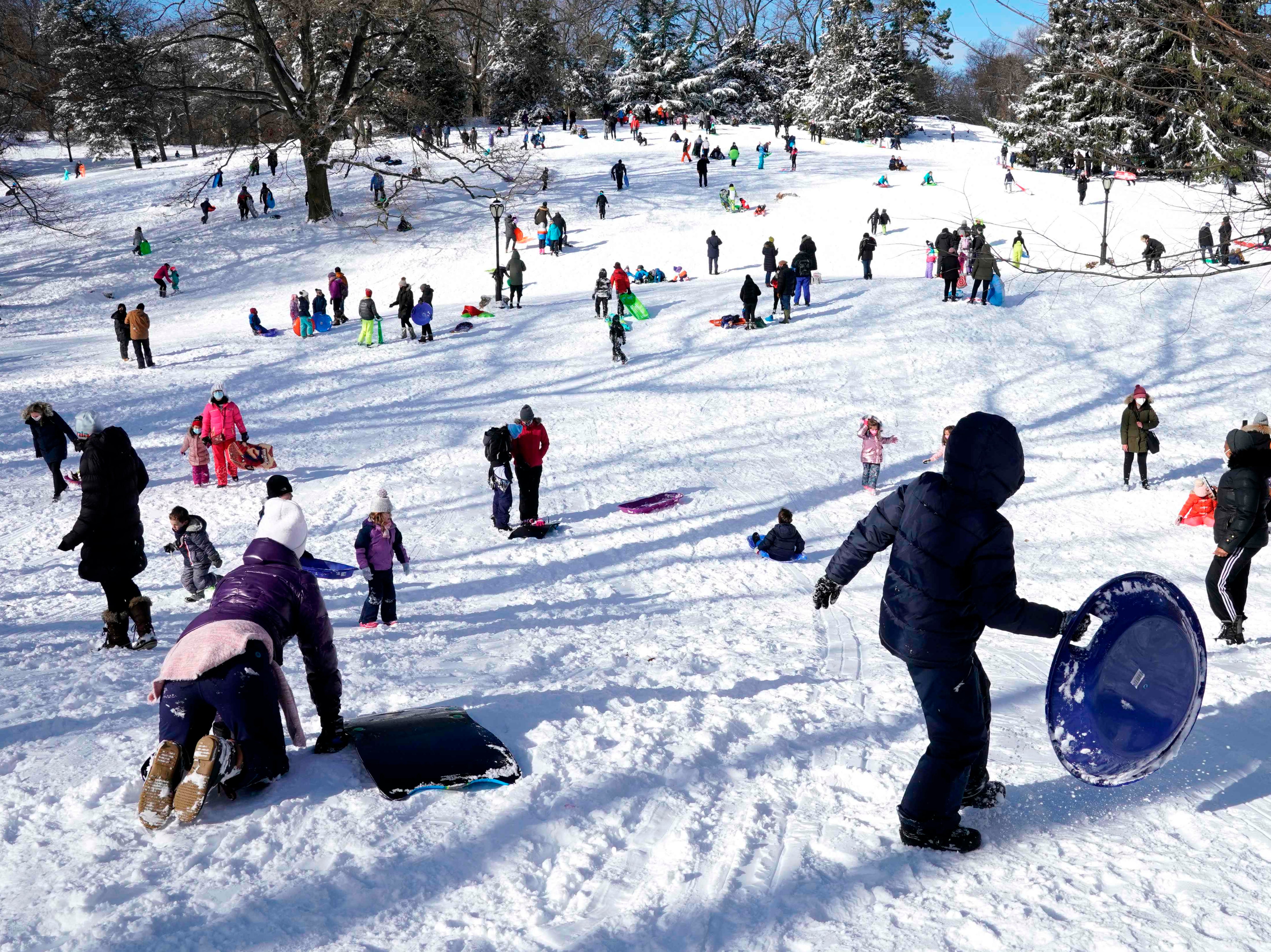 People go sledding on Central Park's Pilgrim Hill in New York on December 17, 2020.
