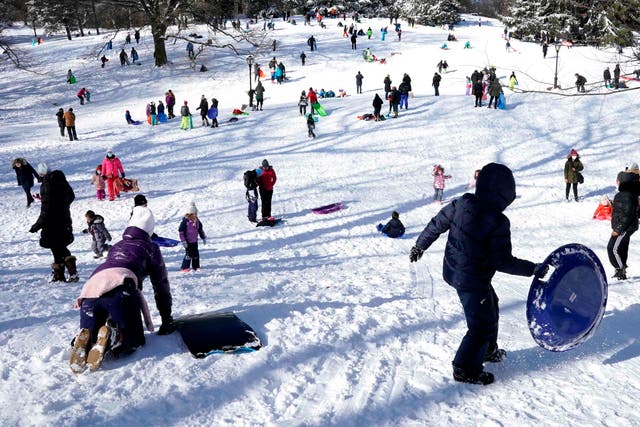 <p>People go sledding on Central Park's Pilgrim Hill in New York on December 17, 2020.</p>