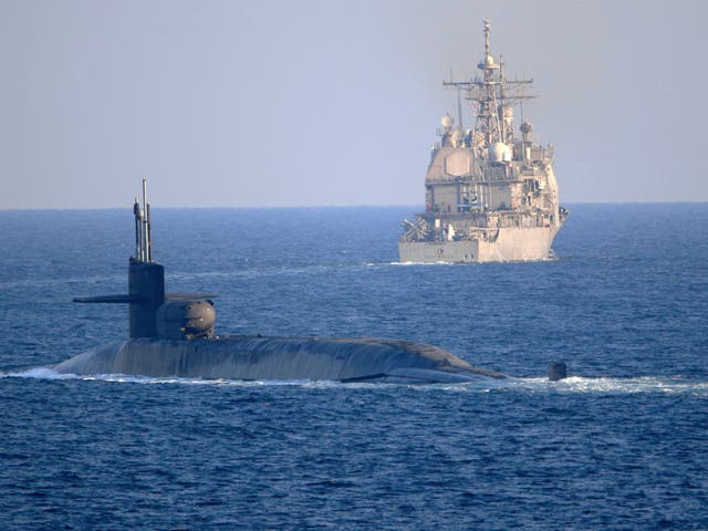 <p>USS Georgia, front, with the guided-missile cruiser USS Port Royal, transit the Strait of Hormuz</p>