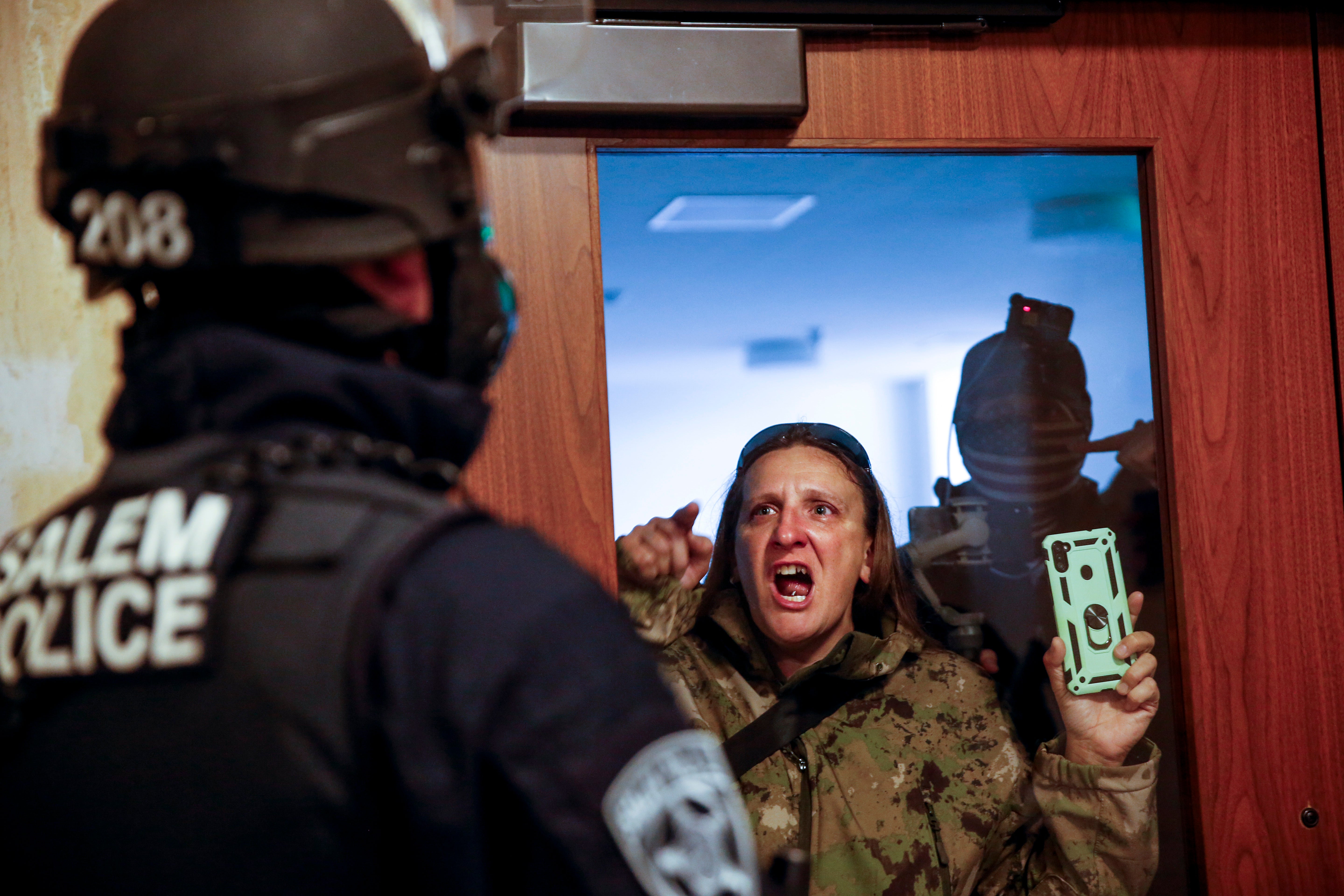 A protester screams at Salem police during the demonstration
