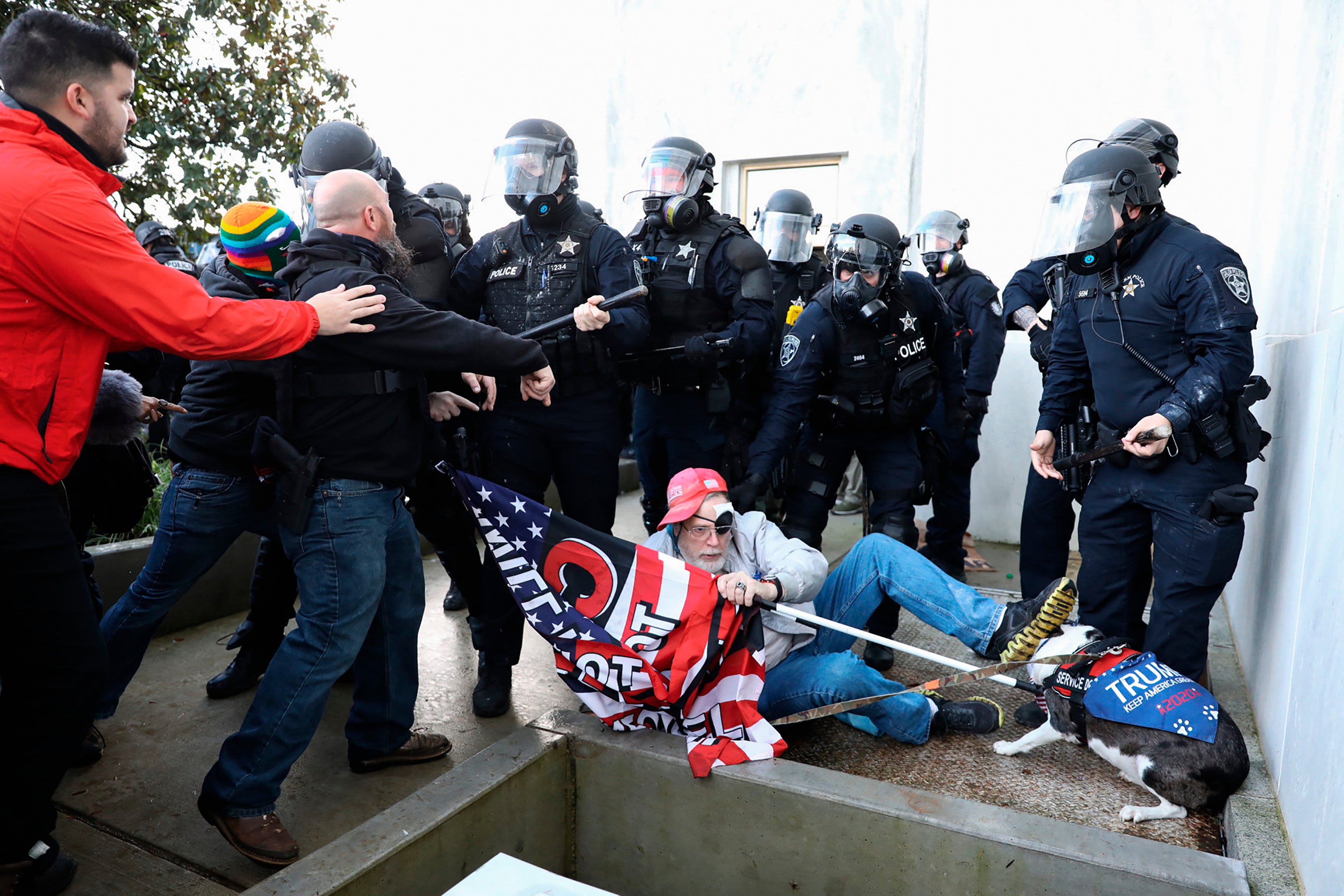 Law enforcement officers and right-wing protesters clash outside the Oregon State Capitol