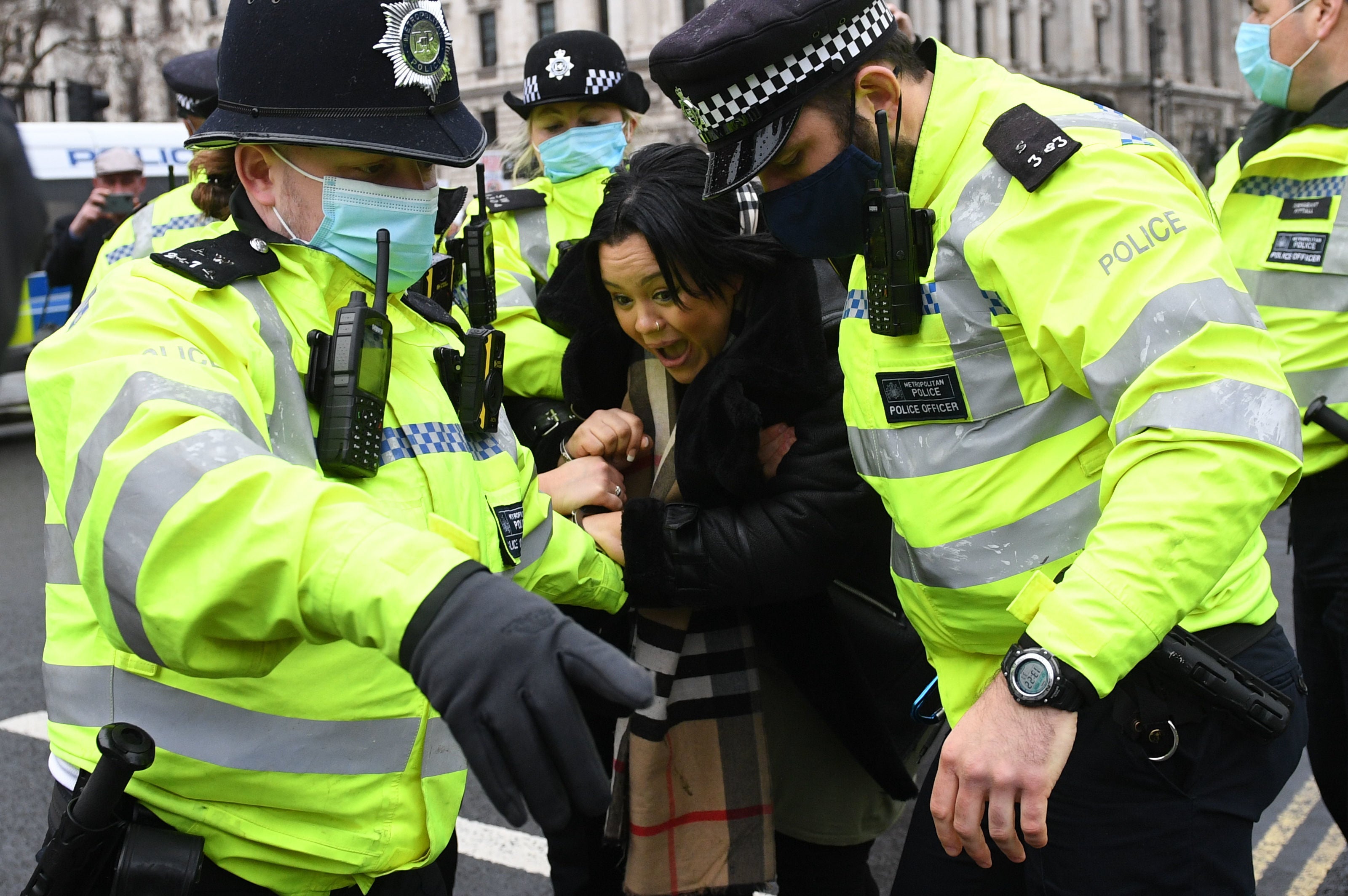 A women is detained for attending an anti-vaccination protest in London during the pandemic on 14 December, 2020.