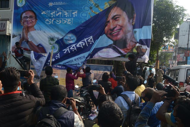 <p>Bharatiya Janata Party supporters tear off a banner with a picture of West Bengal Chief Minister Mamata Banerjee Bharatiya Janata Party supporters block a road during a 12-hour general strike in North Bengal called by BJP to protest against the West Bengal state government in Siliguri on December 8, 2020</p>