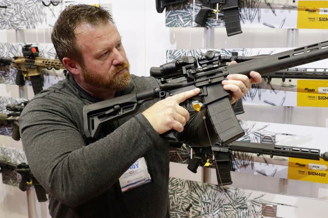 <p>Bryan Oberc, Munster, Ind, tries out an AR-15 from Sig Sauer in the exhibition hall at the National Rifle Association Annual Meeting in Indianapolis</p>