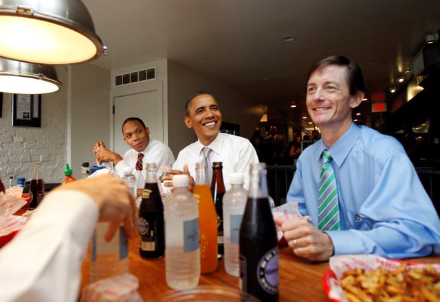 Bruce Reed, right, sitting with Barack Obama during a dinner. Mr Reed was named Joe Biden’s deputy chief of staff. 
