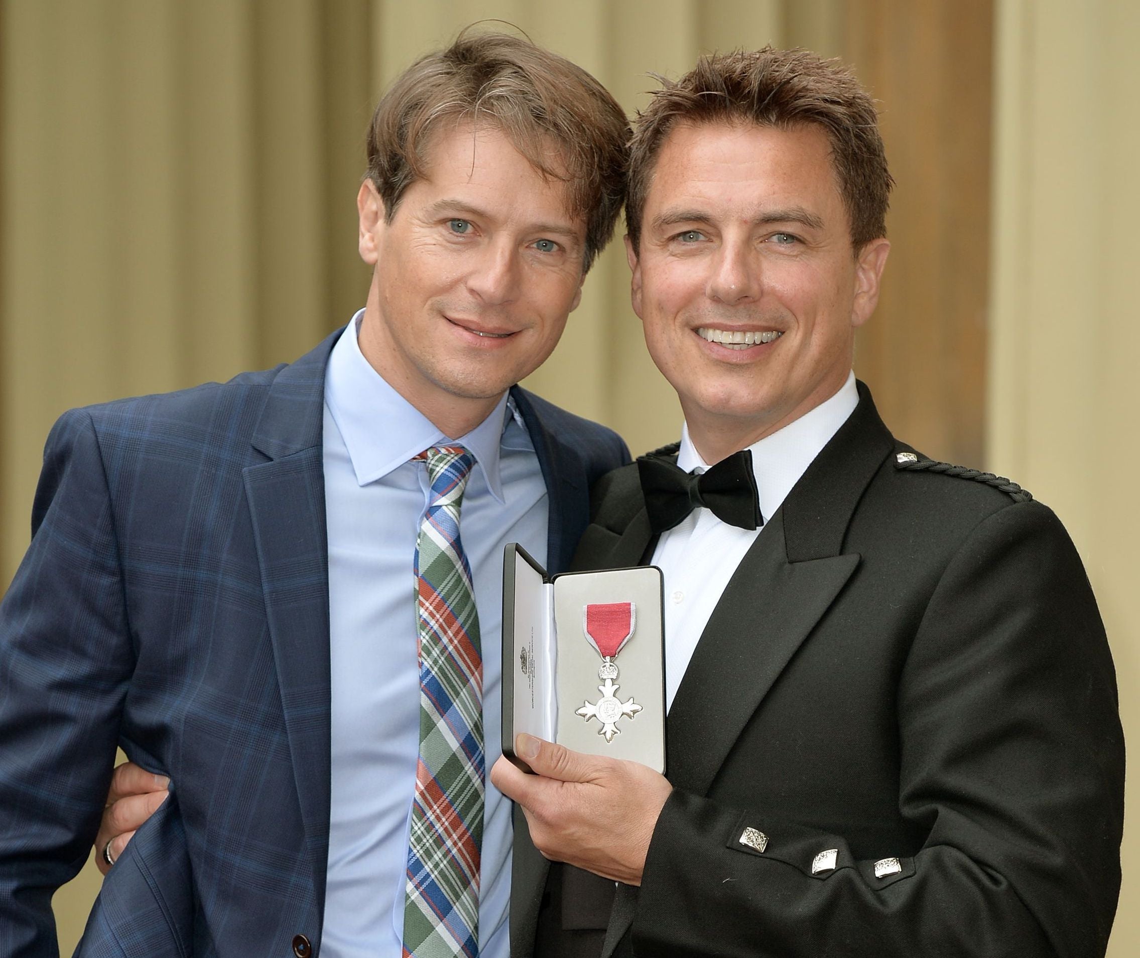 Barrowman with his husband, Scott Gill, after being awarded an MBE at Buckingham Palace, October 2014
