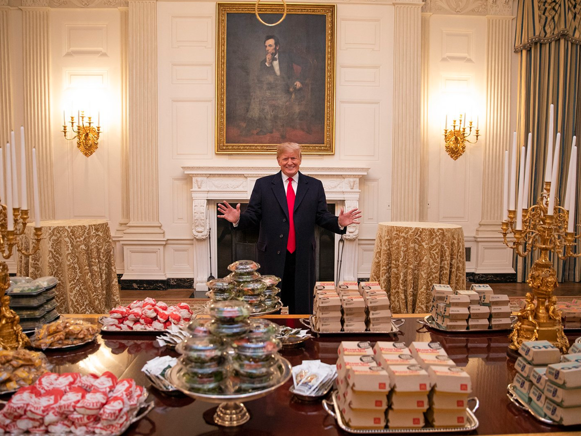 A delighted Donald Trump poses with his White House junk food buffet while president