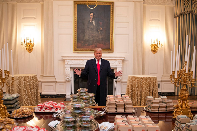 <p>A delighted Donald Trump poses with his White House junk food buffet</p>