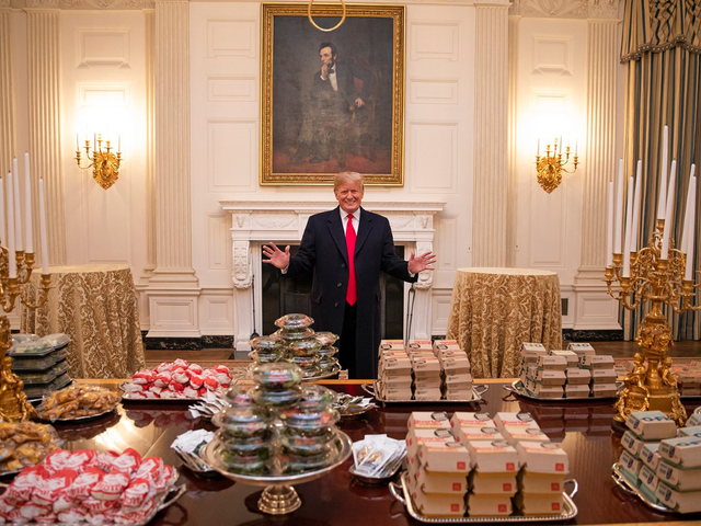 A delighted Donald Trump poses with his White House junk food buffet