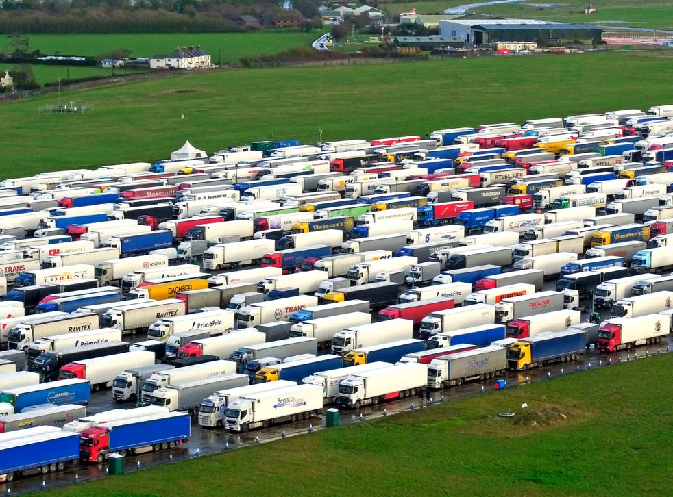 <p>Freight lorries lined up in Manston, Kent, after French authorities announced that journeys from the UK will be allowed to resume after the coronavirus ban was lifted, but those seeking to travel must have a negative test result</p>