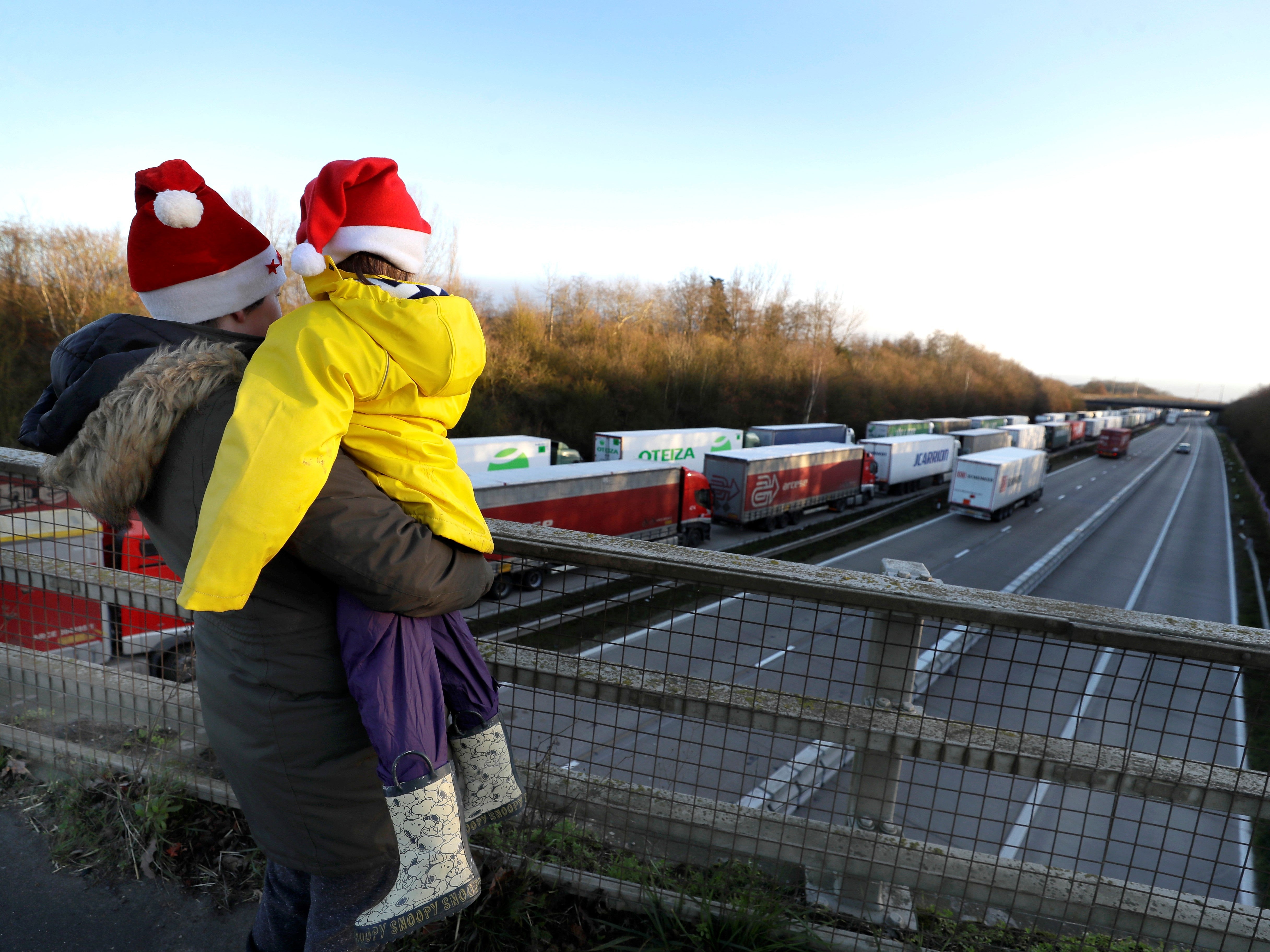 A mother and child look at parked up lorries on Christmas Day
