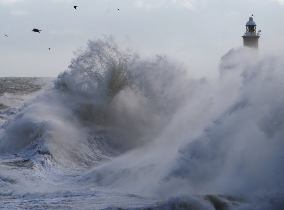 Waves crash against the pier wall at Tynemouth on the North East coast of England