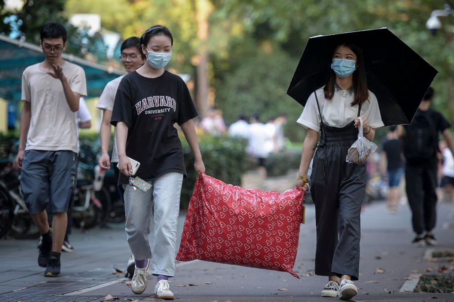 Students arrive on campus at Huazhong University of Science and Technology, in Wuhan