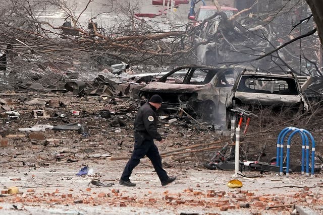 A law enforcement member walks past damage from an explosion in downtown Nashville on Friday 25 December, 2020