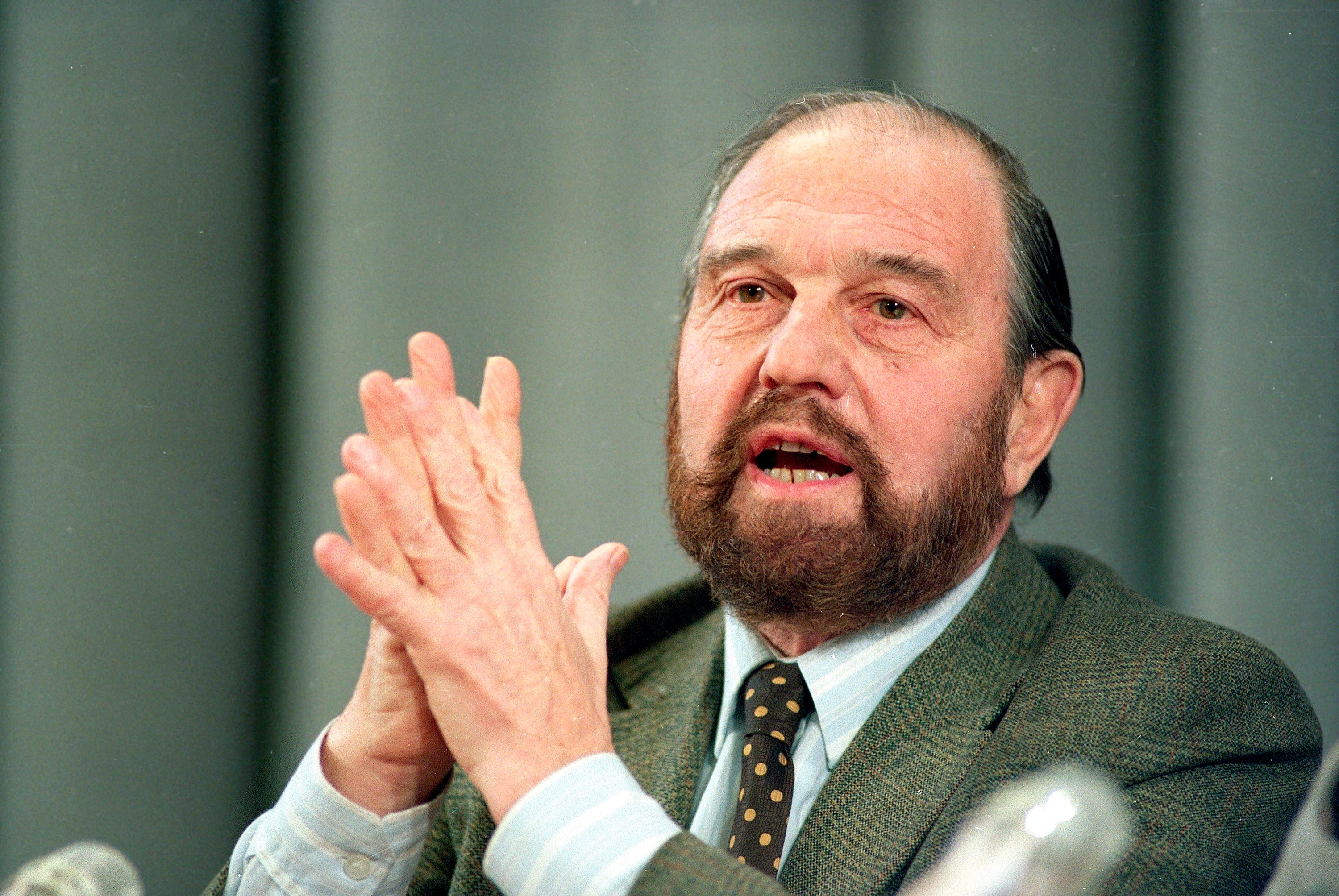 Blake gestures during a January 1992 news conference in Moscow, his home for 54 years after escaping from a London prison