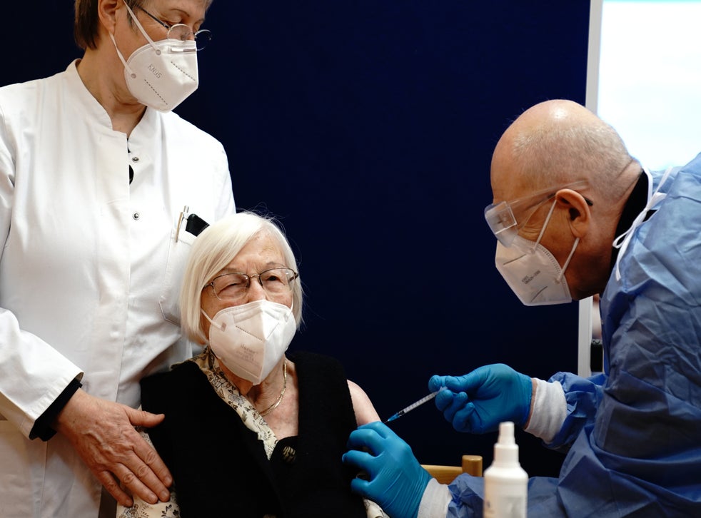 101-year-old Gertrud Haase is vaccinated against the coronavirus by doctor Fatmir Dalladaku in the Agaplesion Bethanien Sophienhaus care home, on the first day of the nationwide launch of Covid-19 vaccinations on 27 December in Berlin, Germany