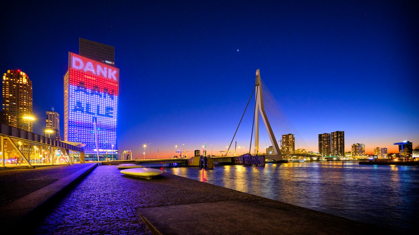 Rotterdam city skyline at twilight with the Erasmus Bridge in the background