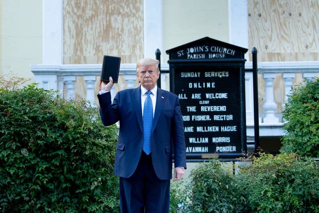 Donald Trump poses with a Bible that isn’t his outside St John’s Episcopal Church in Washington amid racial justice protests on 1 June.