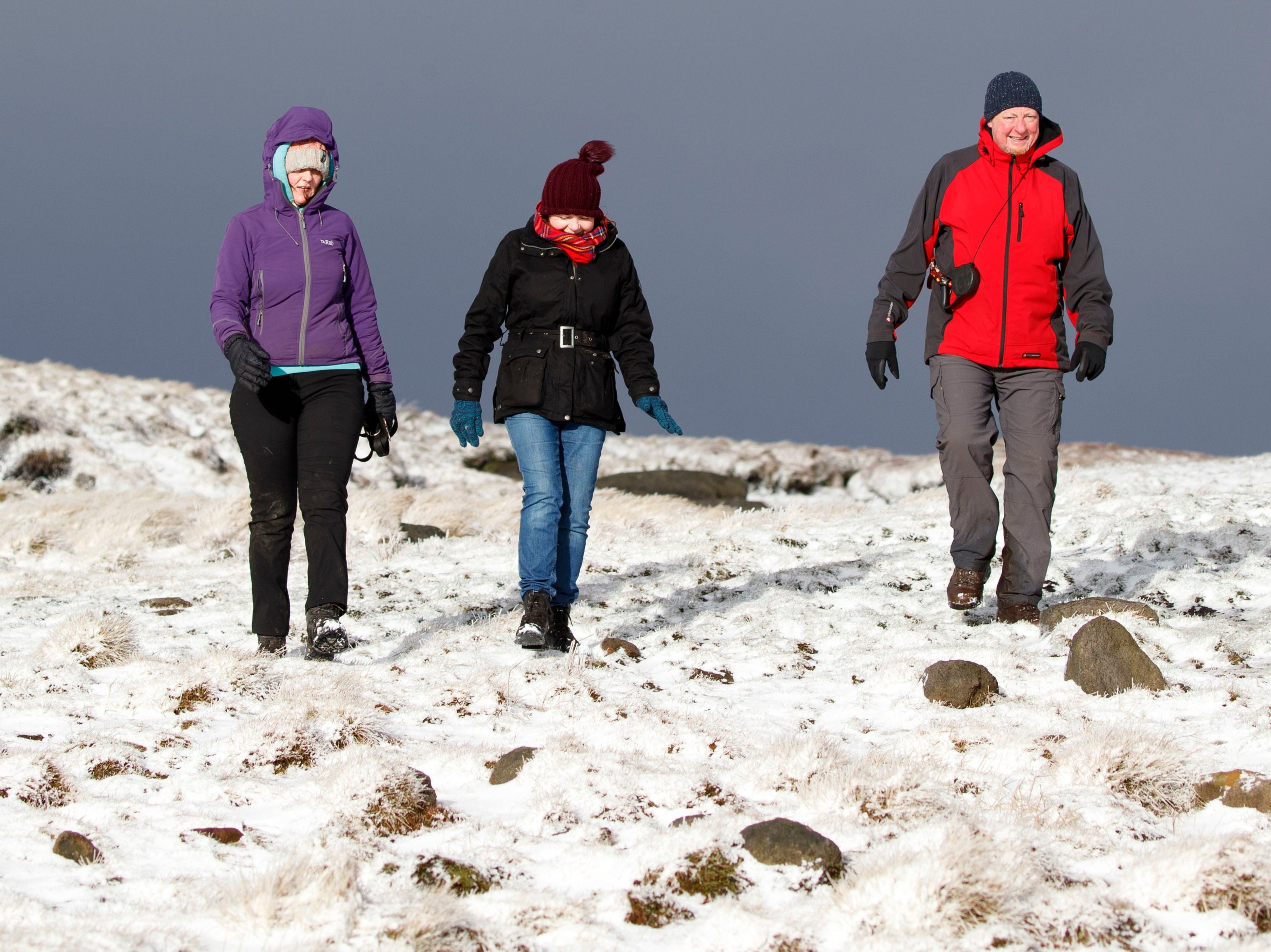 Hikers trudge through snow in the Peak District in Derbyshire