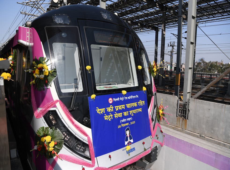 <p>Flowers adorn the front of India’s first driverless metro train at a station during its inauguration in New Delhi on December 28, 2020</p>