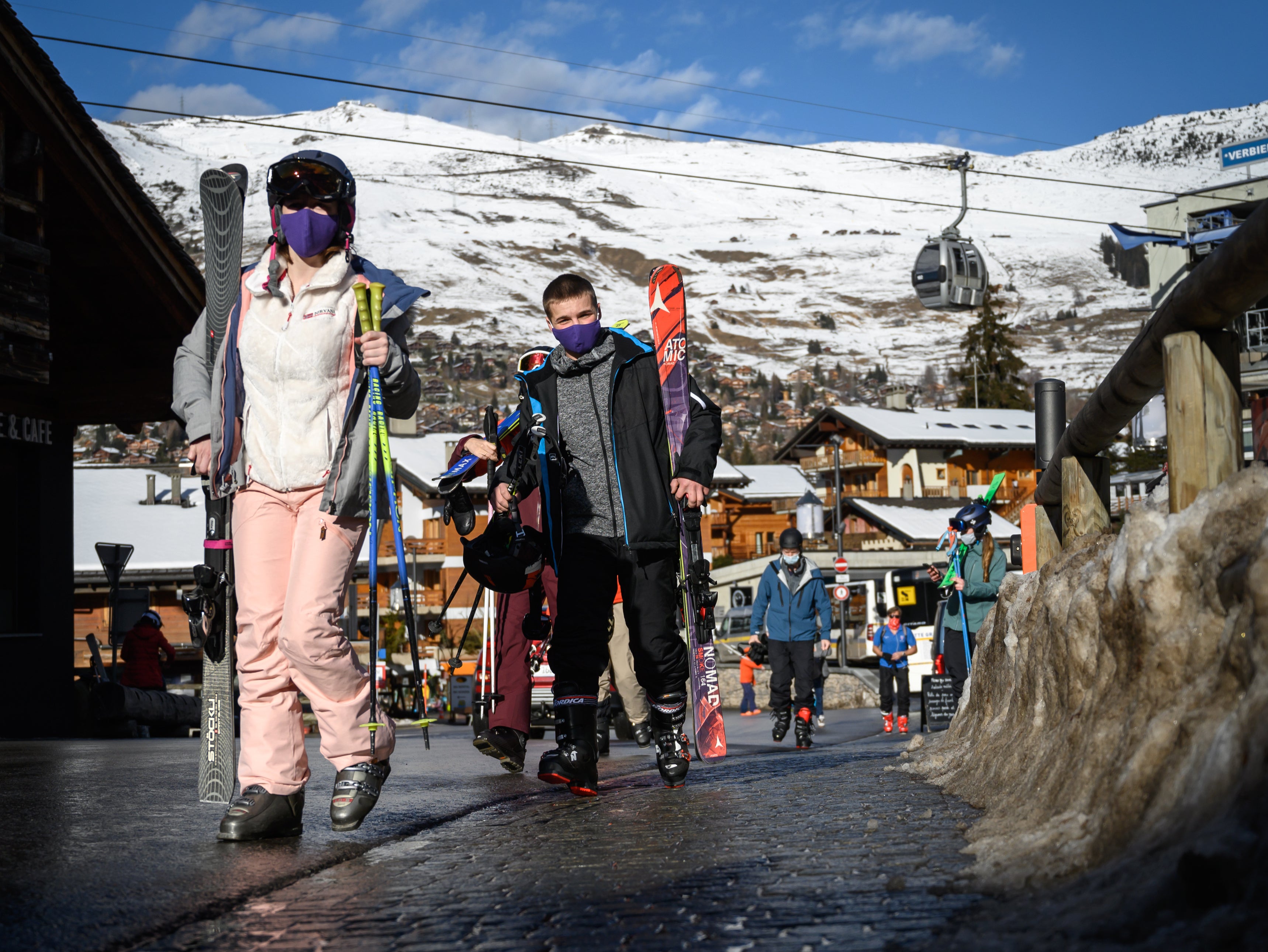 Skiers walk in the Alpine resort of Verbier on 22 December