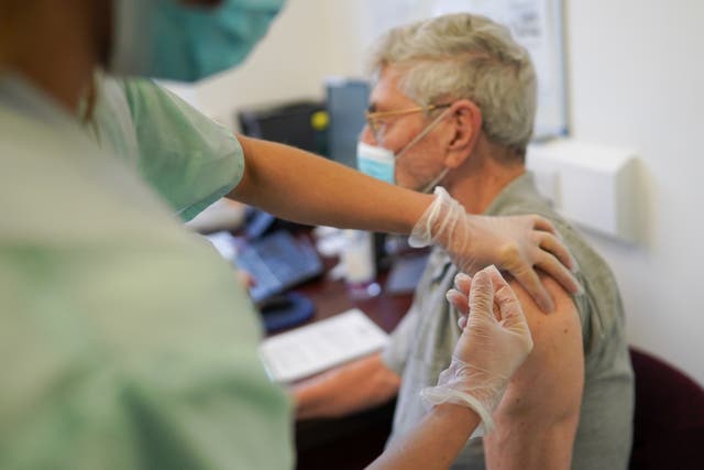 A man receives his Pfizer BioNTech Covid-19 vaccination from a primary care practitioner in Haxby and Wiggington Surgery on 22 December, 2020 in York, England. A new study warns that the UK must vaccinate at least 2 million people a week in order to prevent a third wave.
