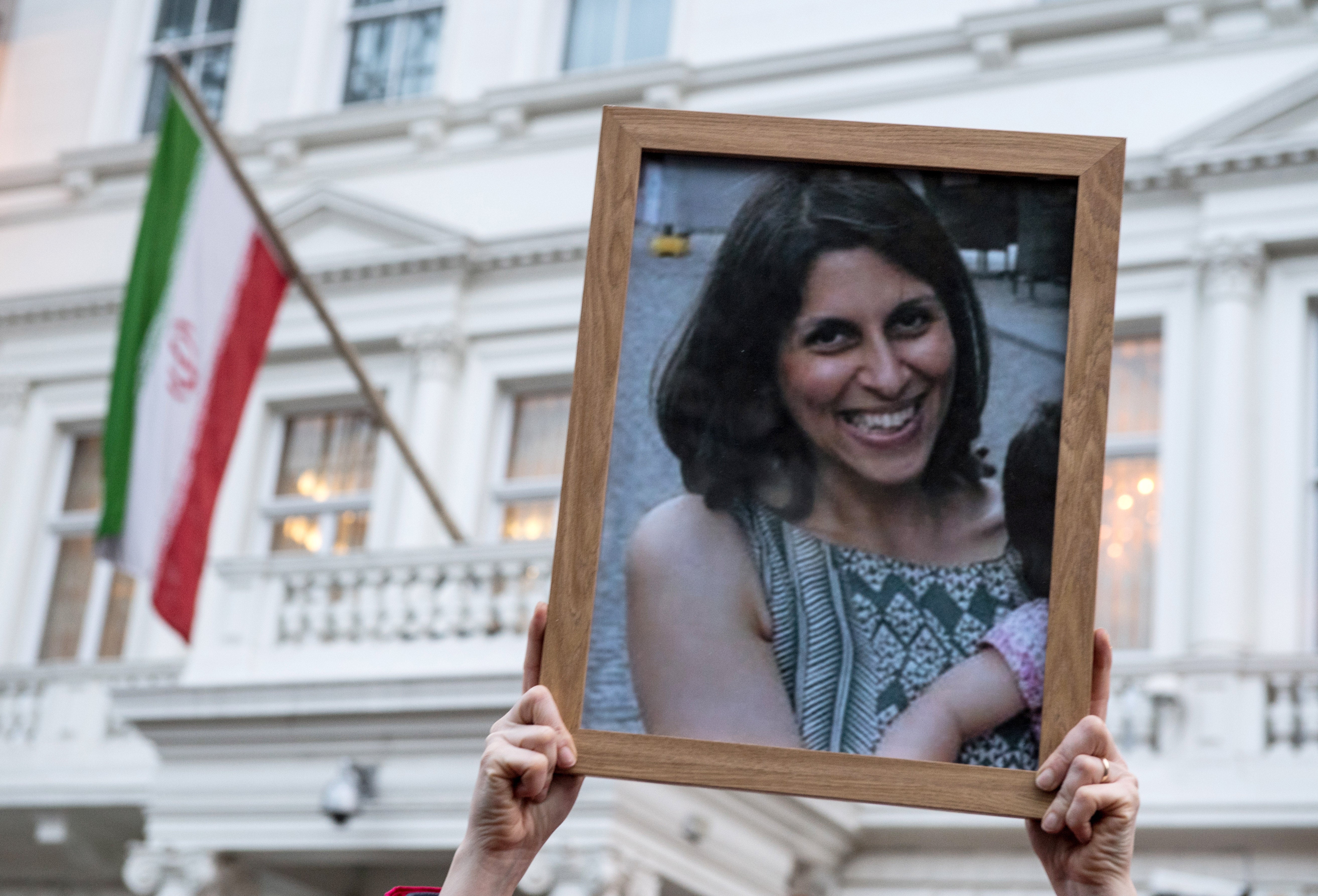 Supporters hold a photo of Nazanin Zaghari-Ratcliffe during a vigil for British-Iranian mother, Nazanin Zaghari-Ratcliffe, imprisoned in Tehran outisde the Iranian Embassy on 16 January, 2017 in London, England. She has been detained in Iran since 2016.