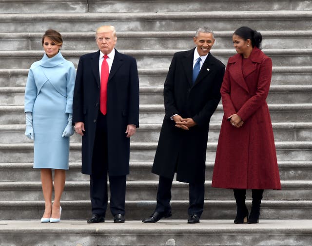 First Lady Melania Trump, President Donald Trump, former President Barack Obama and Michelle Obama stand on the East front steps of the US Capitol after inauguration ceremonies on 20 January, 2017
