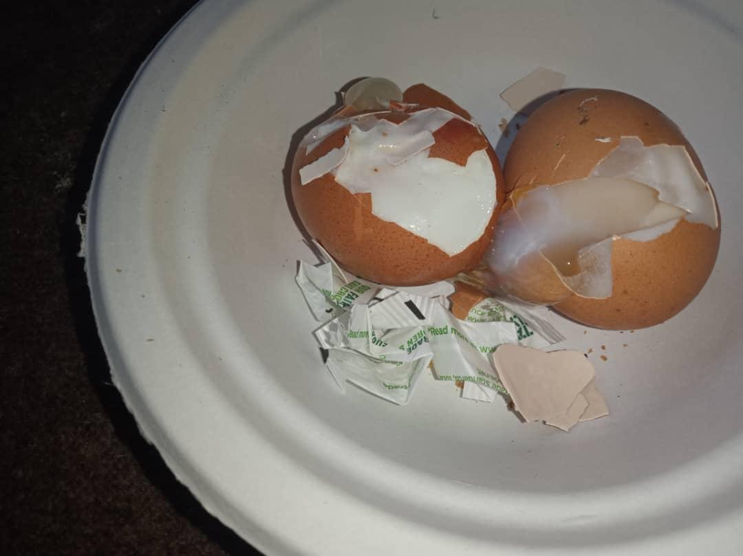 A photo shows eggs that appear to be undercooked, which asylum seekers say they were served at the Penally military camp.