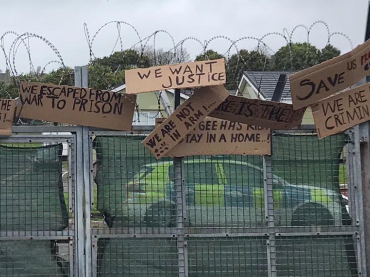 Signs made by asylum seekers housed at the Penally military camp call for ‘justice’. Asylums seekers have repeatedly raised concerns over the food and conditions at the site.