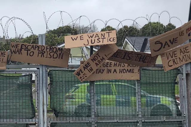 Signs made by asylum seekers housed at the Penally military camp call for ‘justice’.  Asylums seekers have repeatedly raised concerns over the food and conditions at the site.