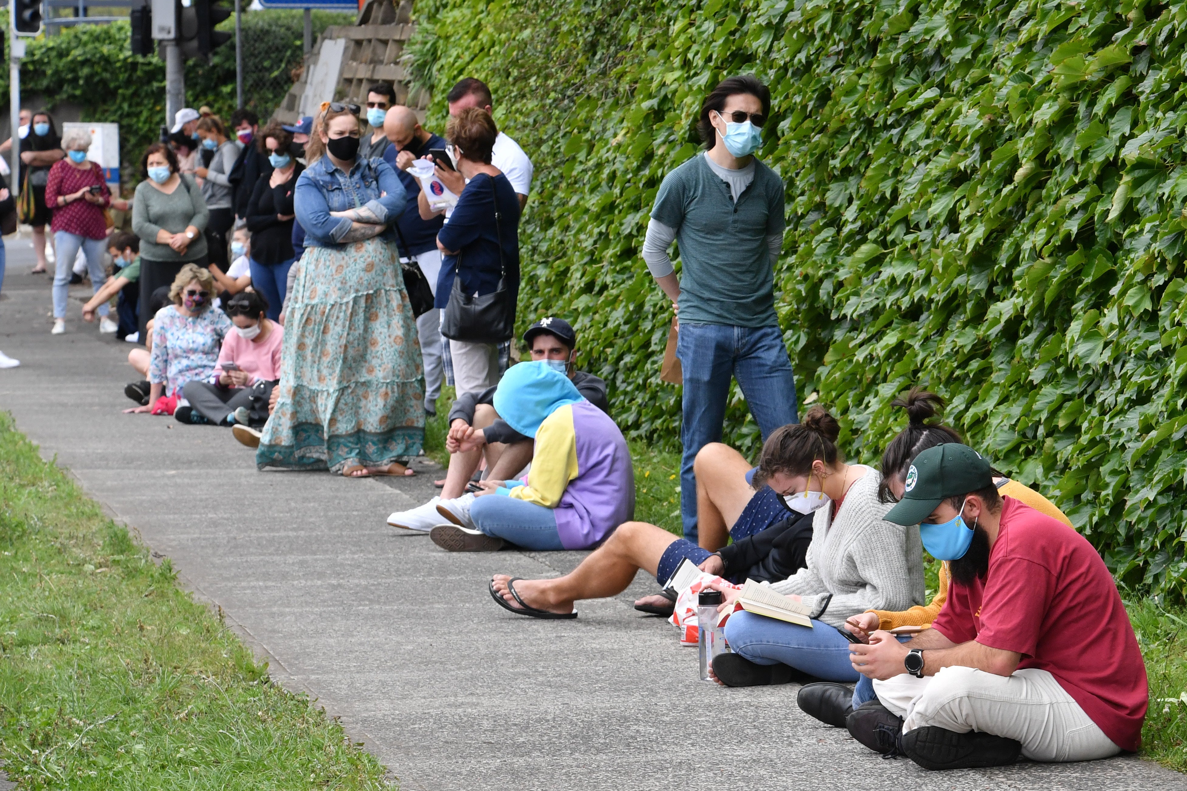 Long lines of people queue for COVID-19 testing at the Wollongong District Hospital in Wollongong, Australia