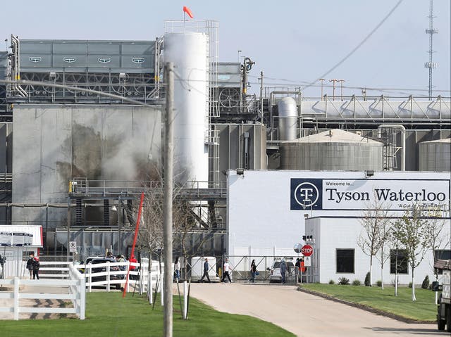 <p>Tyson’s Fresh Meat workers file in for a tour of safety measures put into place after the plant in Waterloo, Iowa, had to shut down due to a Covid-19 outbreak</p>