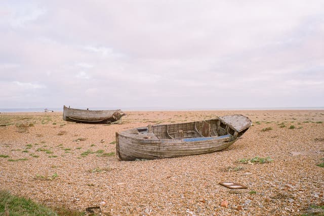 <p>Boats in the flat landscape of Dungeness</p>