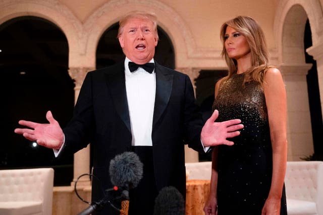 In this file photo taken on December 31, 2019, US President Donald Trump and First Lady Melania Trump speak to the press outside the grand ballroom as they arrive for a New Year's celebration at Mar-a-Lago in Palm Beach, Florida. - Trump's re-election team on January 2, 2020, revealed that he sits atop a staggering campaign war chest, underlining the scale of the challenge facing the US president's Democratic rivals at the start of an election year. In the fourth quarter of 2019, even as Trump was mired in a political scandal that resulted in his impeachment by the House of Representatives, he came out on top, raising a staggering $46 million. (Photo by JIM WATSON / AFP) (Photo by JIM WATSON/AFP via Getty Images)
