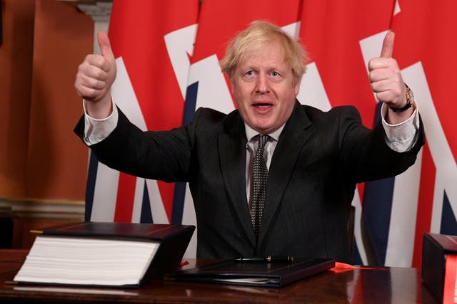 <p>Boris Johnson gives a thumbs up after signing the Brexit trade deal in No 10 on Wednesday 30 December</p>