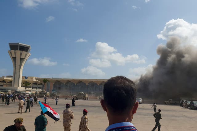 Smoke billows from Aden Airport following the attack which has left at least 25 dead (Photo by Saleh Al-OBEIDI / AFP)