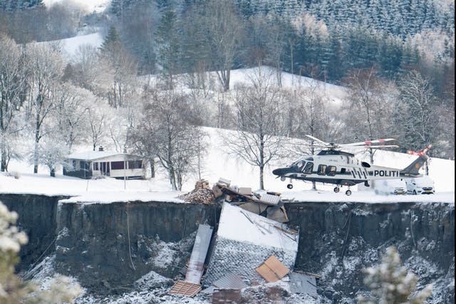 <p>A police helicopter joins the rescue operation in the village of Ask in Gjerdrum municipality near Oslo</p>