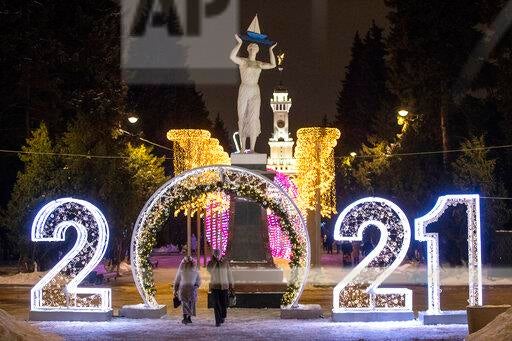 People pass an installation to celebrate New Year in Moscow, Russia