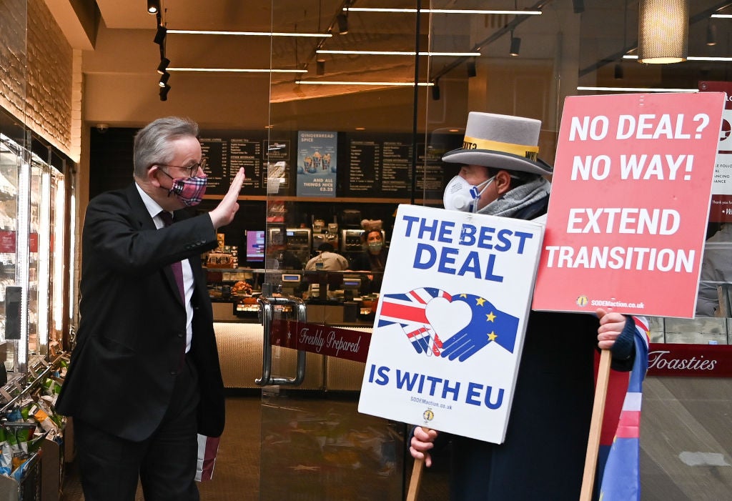 Michael Gove gestures as he passes anti-Brexit demonstrator Steve Bray on 30 November 2020