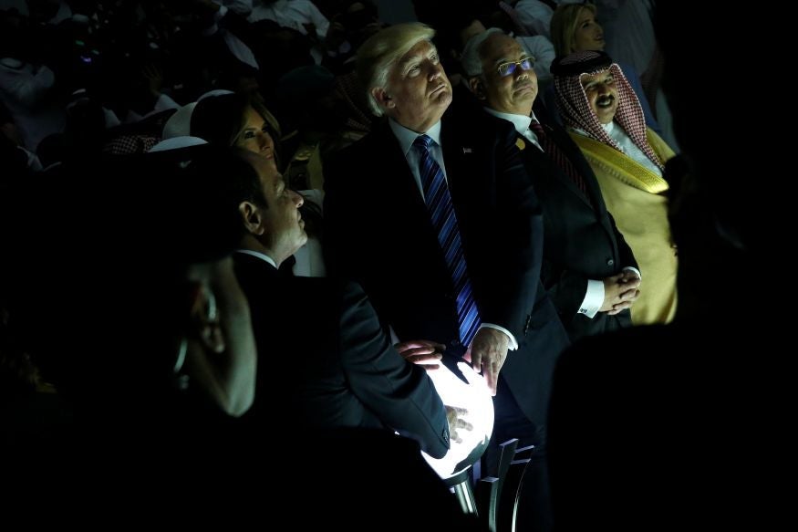 Trump, Saudi Arabia’s king Salman bin Abdulaziz and Egyptian president Abdel Fatah al-Sisi grasp the orb at a summit in Riyadh