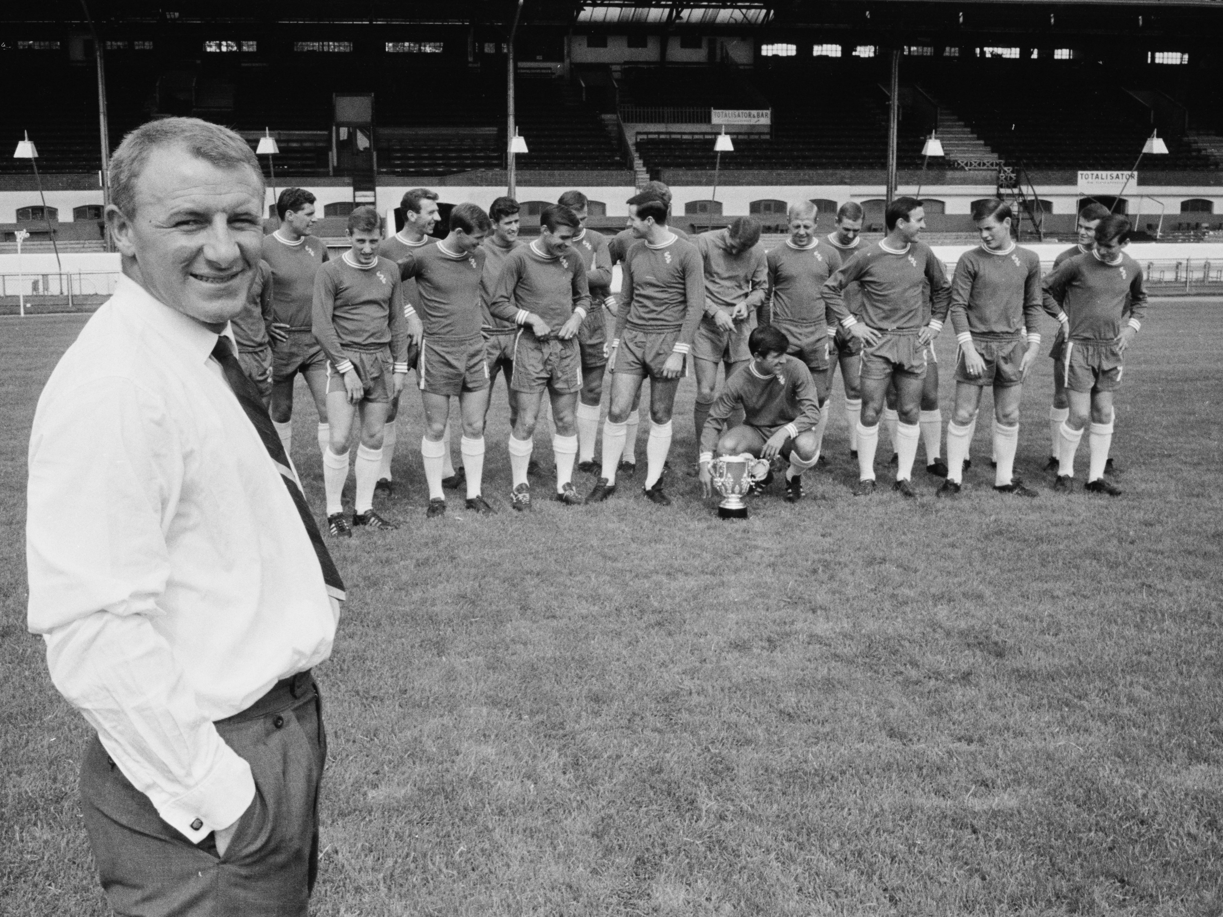 Docherty (foreground) and his Chelsea squad organise for a portrait in 1965
