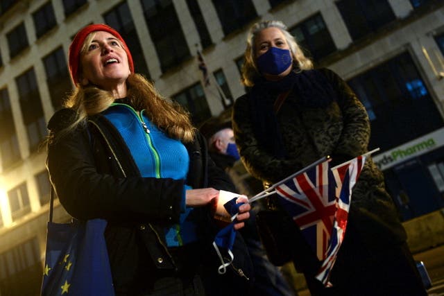 <p>A woman holds the union jack as British people living in Brussels who oppose Brexit hold a candlelit vigil outside the UK embassy</p>