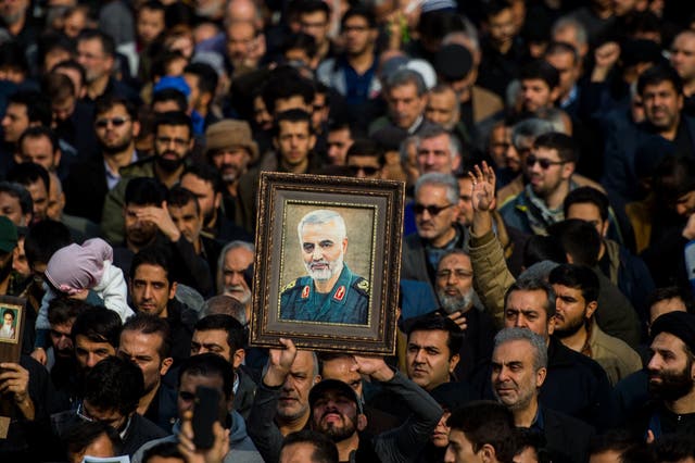 <p>Demonstrators hold up an image of Qassem Soleimani following his death</p>