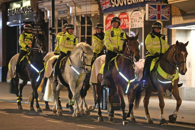 <p>Mounted police patrol St James’s, London, on New Year’s Eve</p>