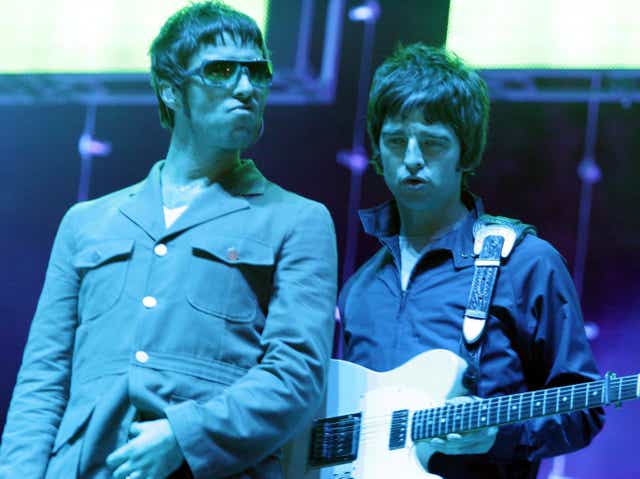 Liam and Noel Gallagher performing together with Oasis in 2005